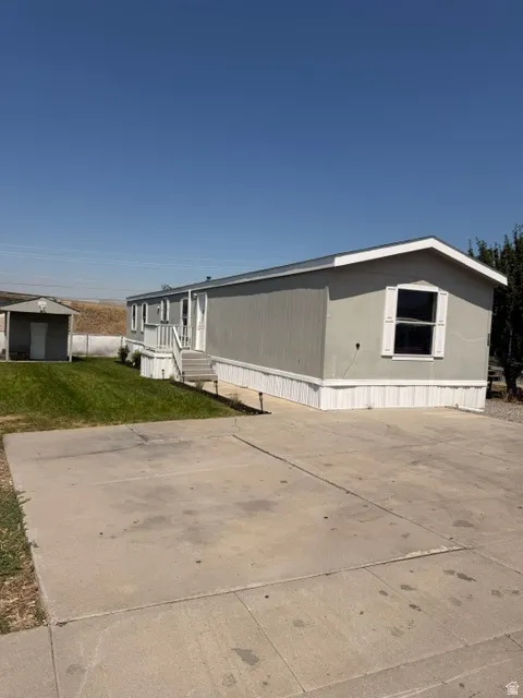 Concrete driveway and a detached storage shed