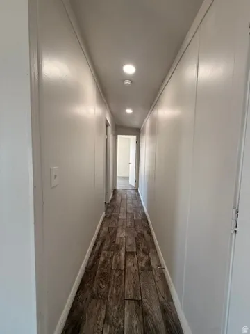 Hallway featuring recessed lighting and wood-finish flooring