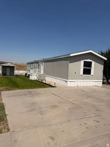 Concrete driveway and a detached storage shed