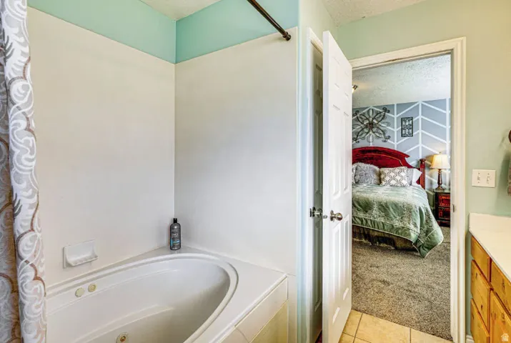 Another view of master bathroom showing large tub