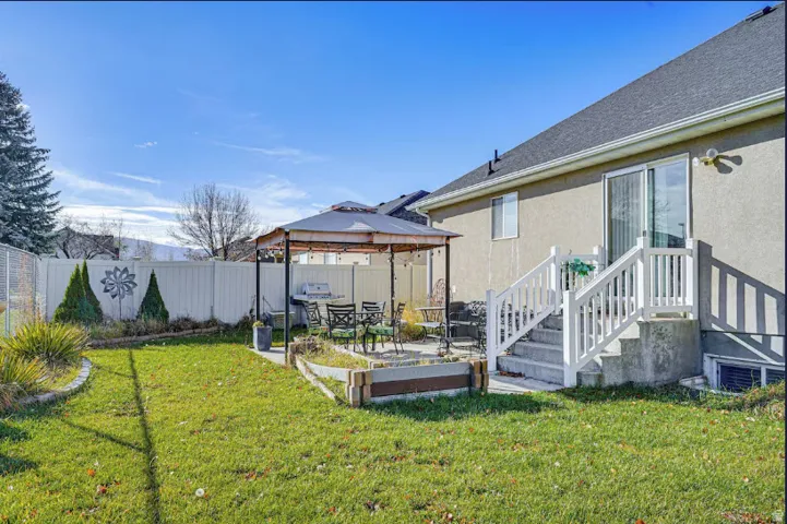 Fully fenced backyard with patio and gazebo