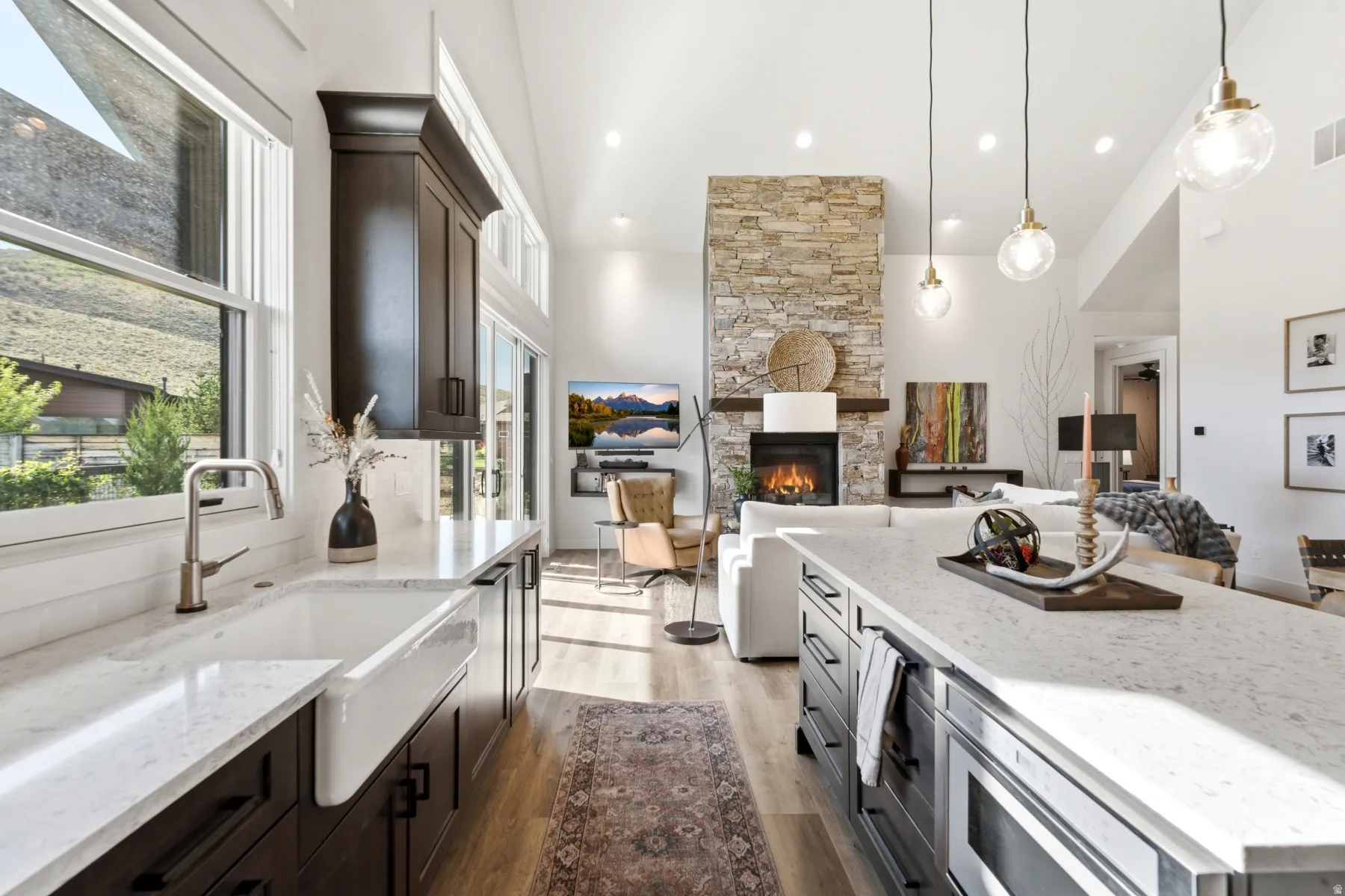 Gourmet kitchen with an apron-front sink, quartz countertops, and dark wood-finish cabinetry