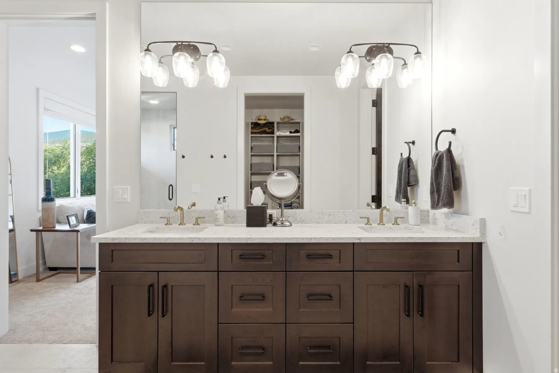 Dual vanity with dark wood-finish cabinetry, light-toned countertop, and integrated sinks