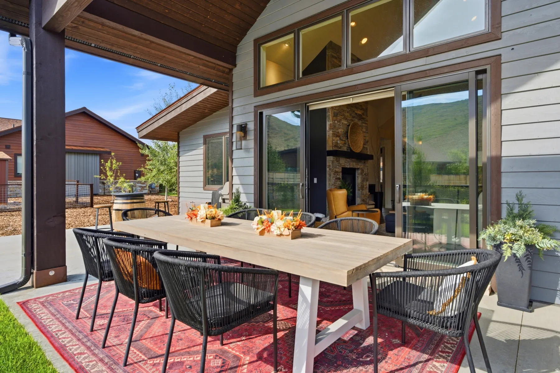 Covered patio featuring a wood-finish ceiling, large sliding glass door, and clerestory windows