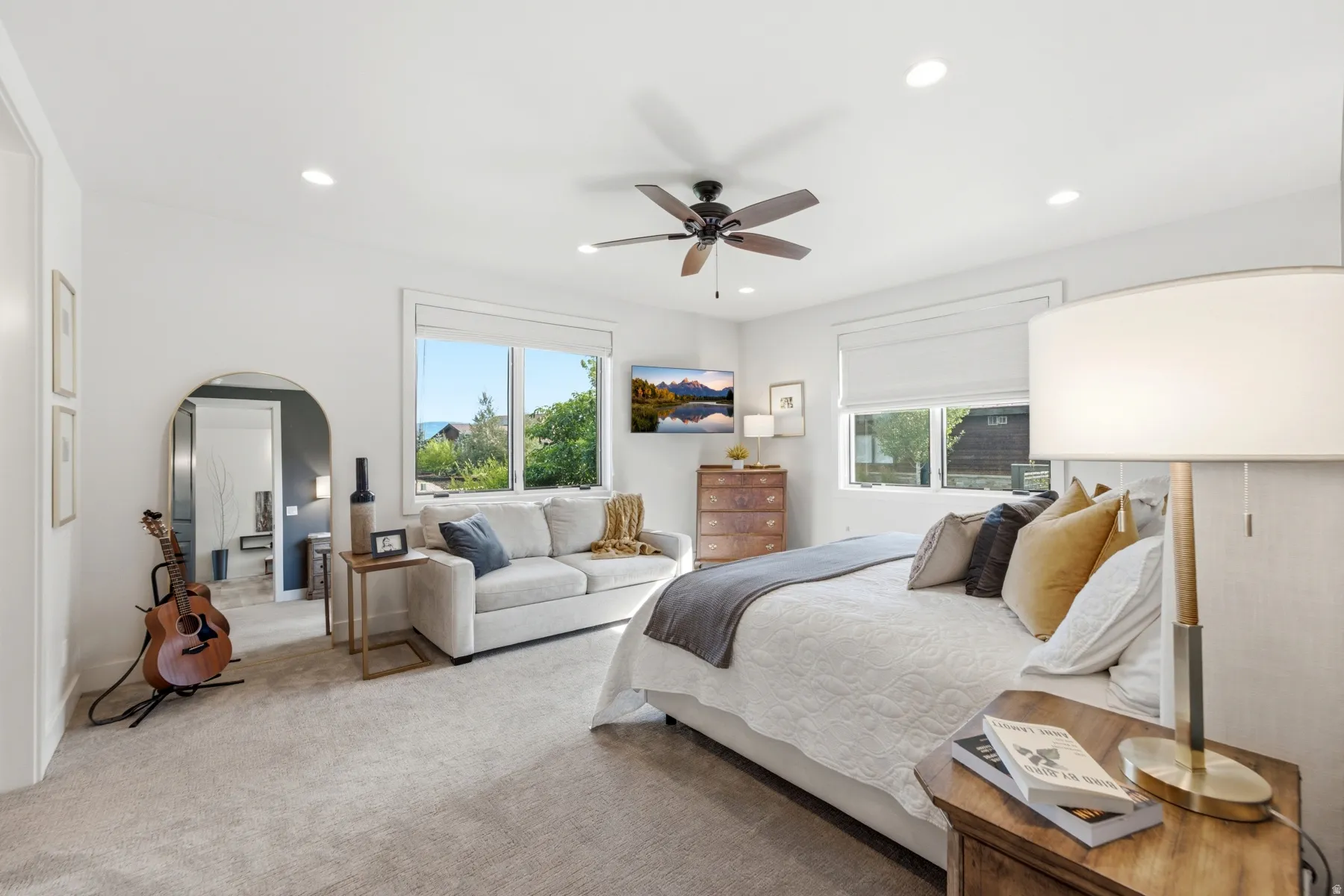 Recessed lighting, ceiling fan, and abundant natural light from multiple windows