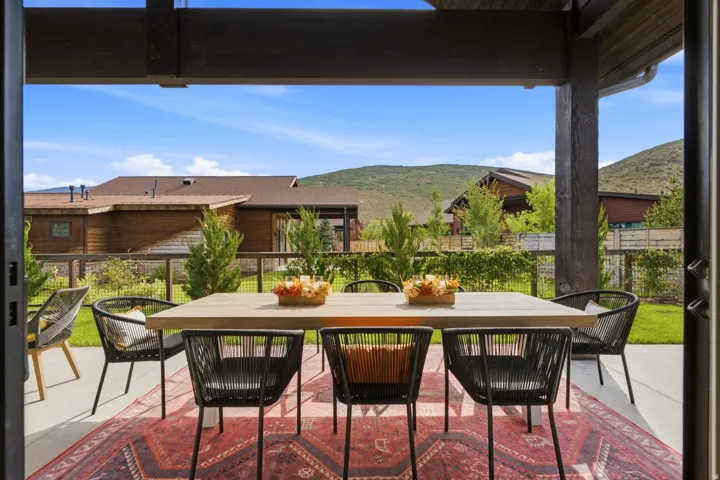 Covered outdoor patio with concrete flooring