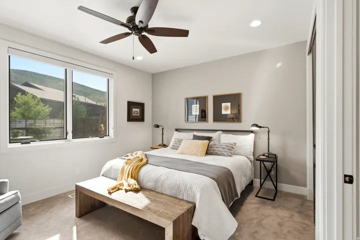 Recessed lighting, ceiling fan with integrated lighting, expansive window, carpeted flooring, and a flat-panel door