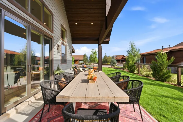 Covered outdoor patio with a plank wood-finish ceiling, recessed lighting, and a sliding glass door