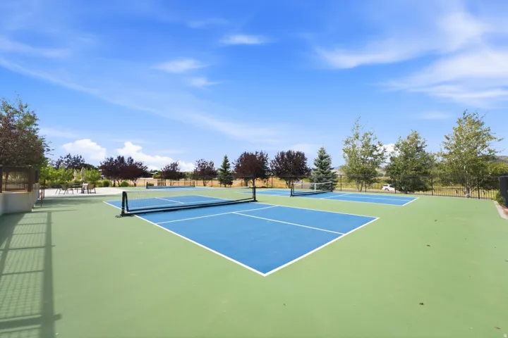 Dual outdoor sport courts with blue and green surfacing