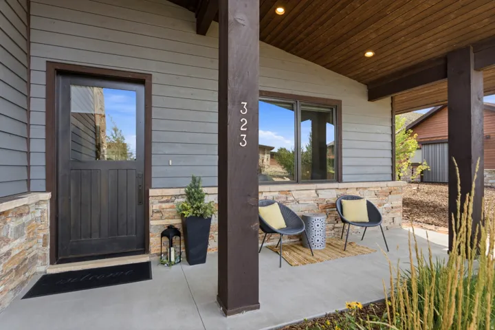 Covered entry with wood-paneled ceiling and recessed lighting