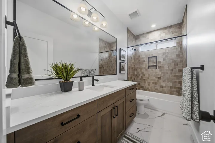 Double vanity with white countertop, wood-finish cabinetry, and matte black fixtures