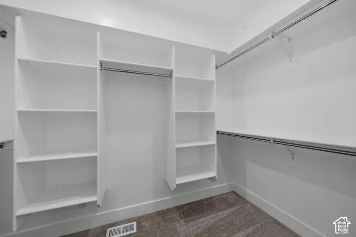 Custom closet organization system with ample shelving and hanging rods