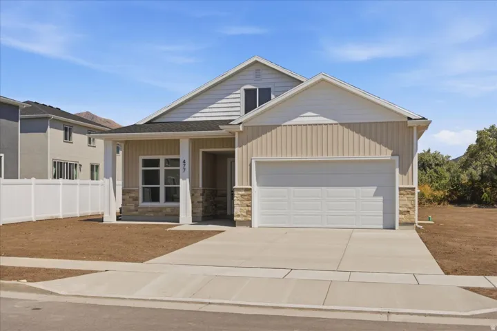 Patio home style residence featuring a covered entry, an attached garage, and a driveway with a concrete sidewalk