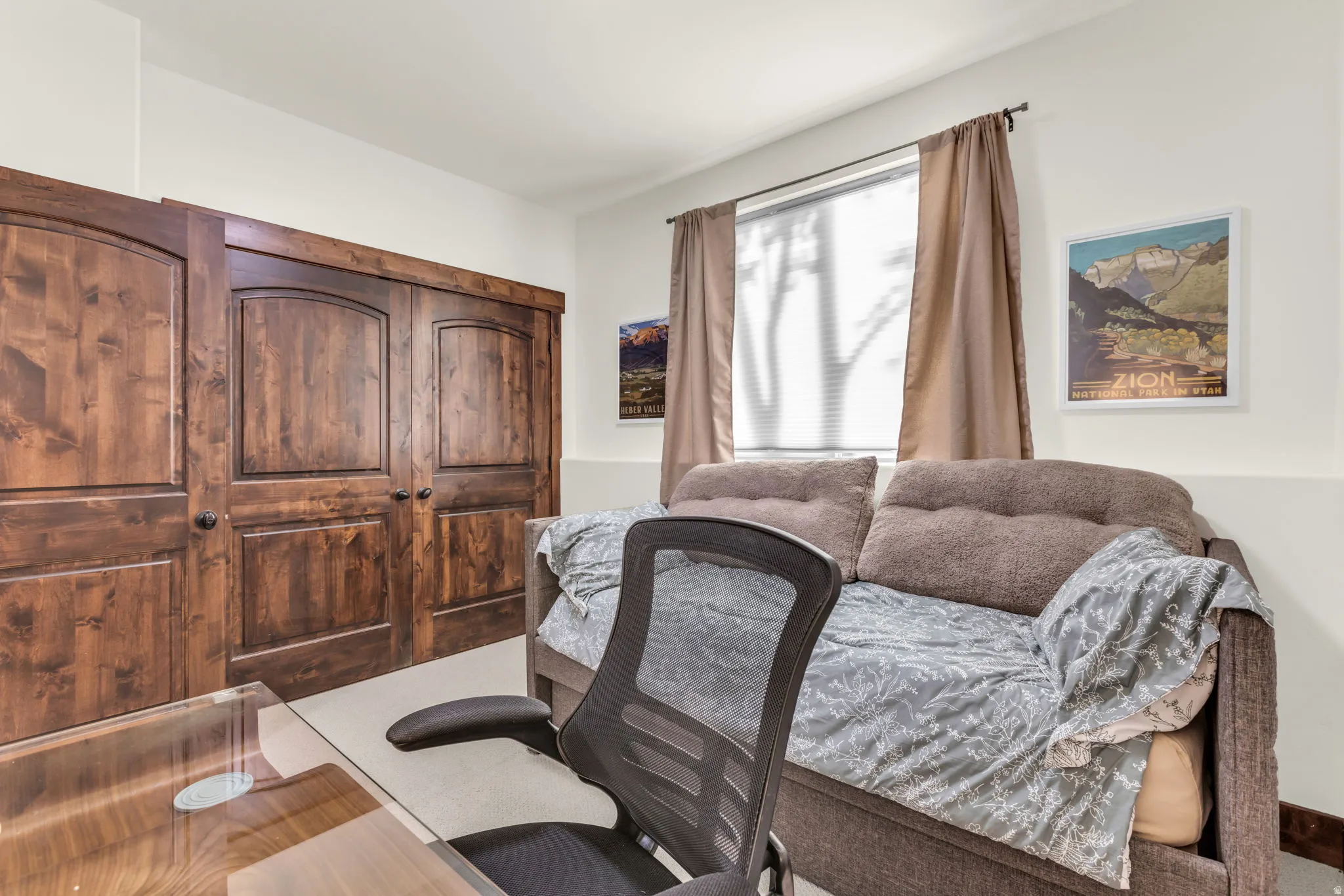 Built-in wood-finish cabinetry featuring arched panel doors