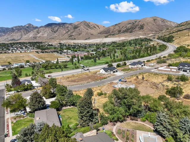 Expansive mountain landscape backdrop, surrounded by established residential areas and undeveloped land