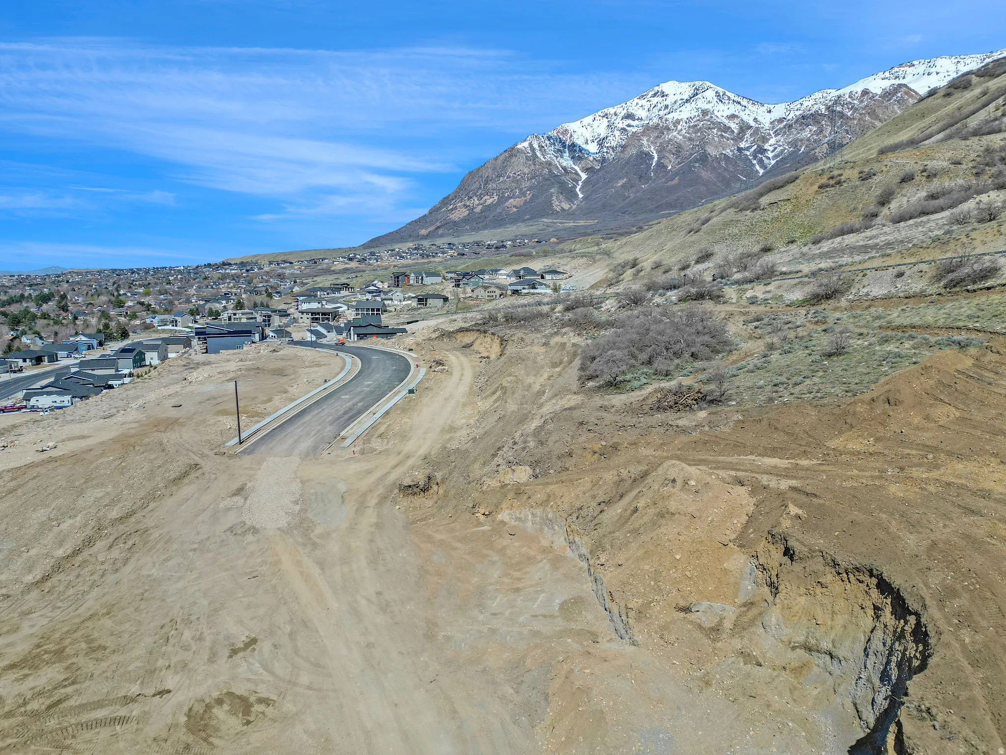 Expansive land parcel with graded terrain and a paved road
