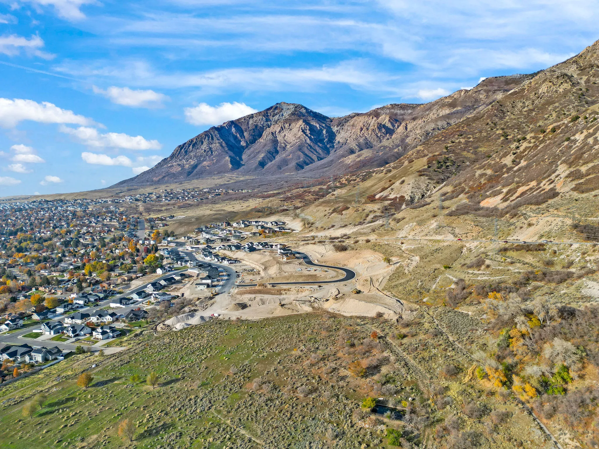 Residential development nestled at the base of a prominent mountain range