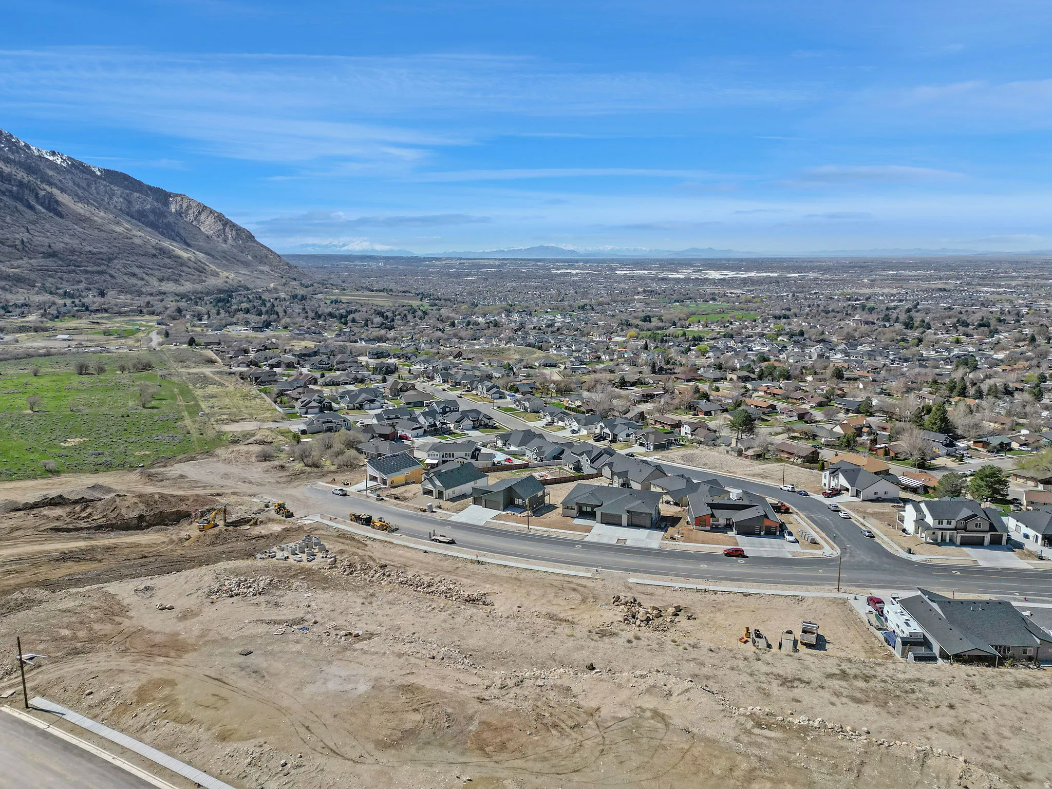 New construction residential development with mountain backdrop and established neighborhood