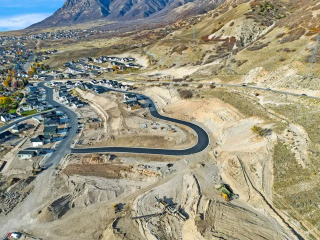 New construction development with paved roads and surrounding mountain terrain