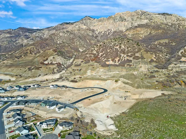 Mountainous terrain, residential development, paved roadways, and natural landscaping