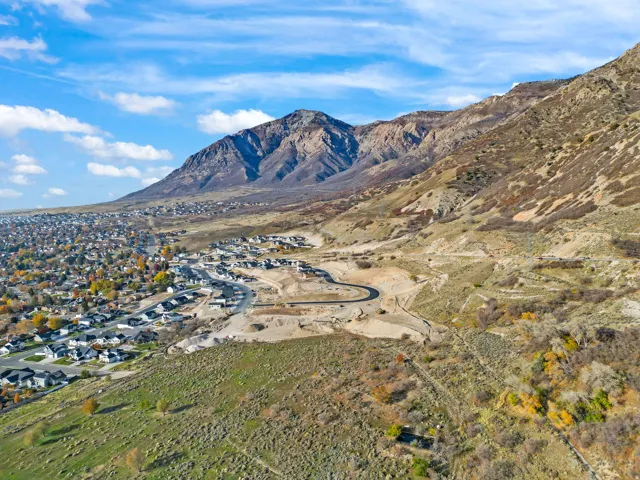 Residential development nestled at the base of a prominent mountain range