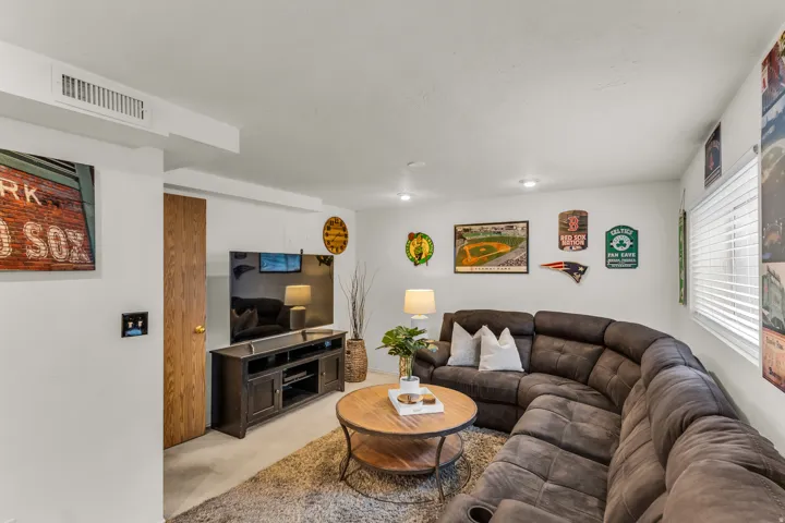 Recessed lighting, wood-finish interior door, window with horizontal blinds, overhead air vent