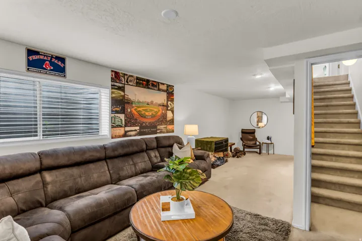 Recessed lighting, carpeted flooring, and a large window with blinds