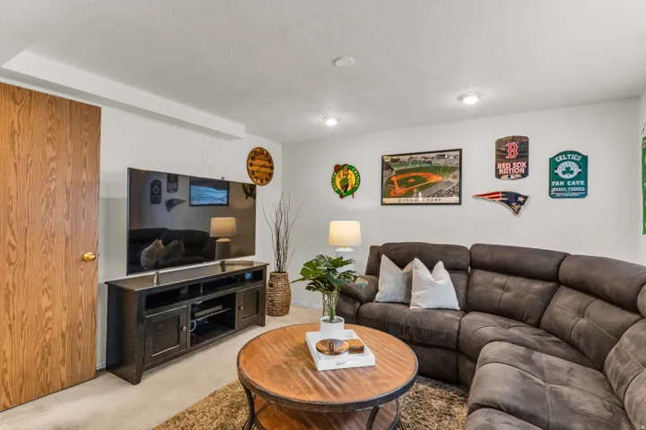 Recessed ceiling lighting, wood-finish door, white painted walls, and light-toned carpet flooring