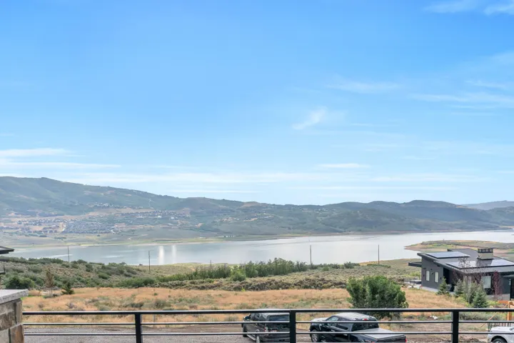 Mountainous landscape with a large body of water, and a sloped terrain