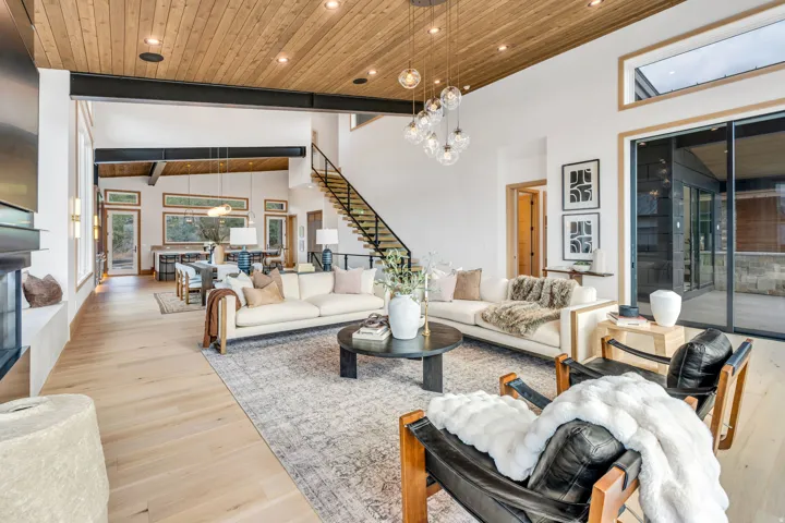 Wood-finish ceiling with recessed lighting and a multi-light pendant