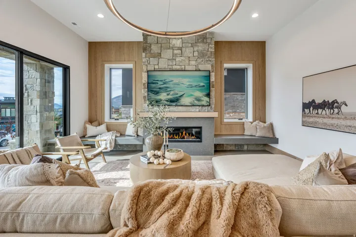 Central stone-clad fireplace with a built-in linear electric firebox