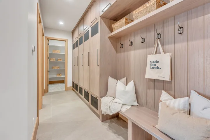 Built-in wood-finish cabinetry, integrated bench seating, and an open shelving unit