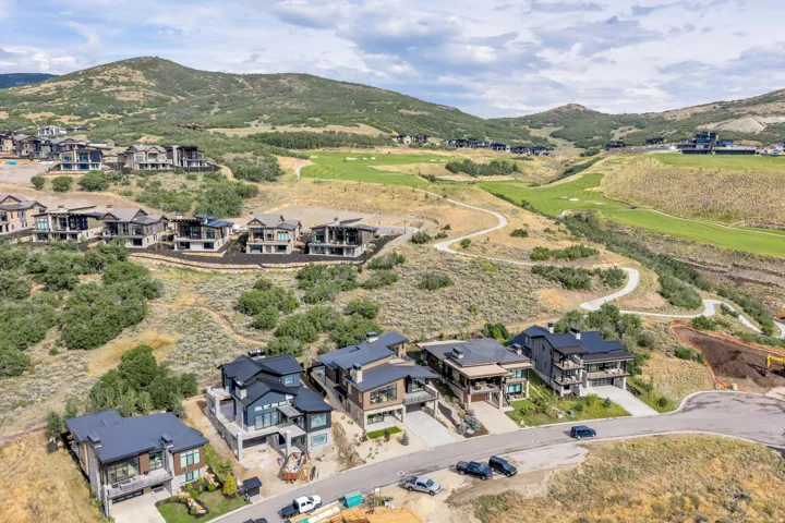Residential development with modern architecture, integrated into a natural, undulating landscape