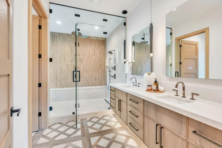 Dual vanity with undermount sinks and light wood-finish cabinetry