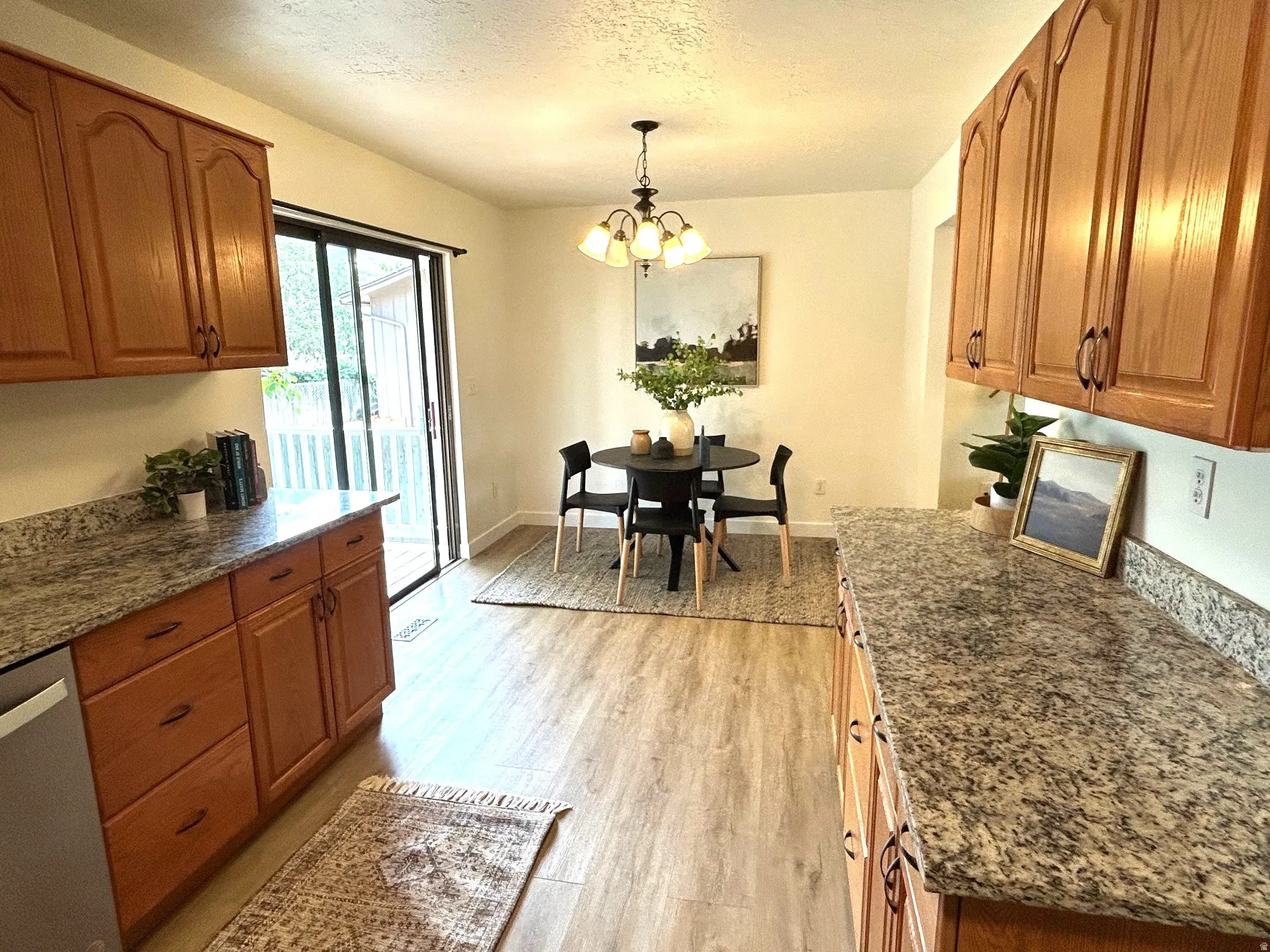 Wood-finish flooring throughout, complemented by light wood cabinetry with dark hardware