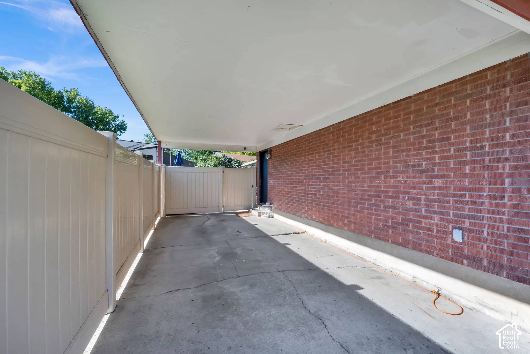 Covered carport with a concrete drive