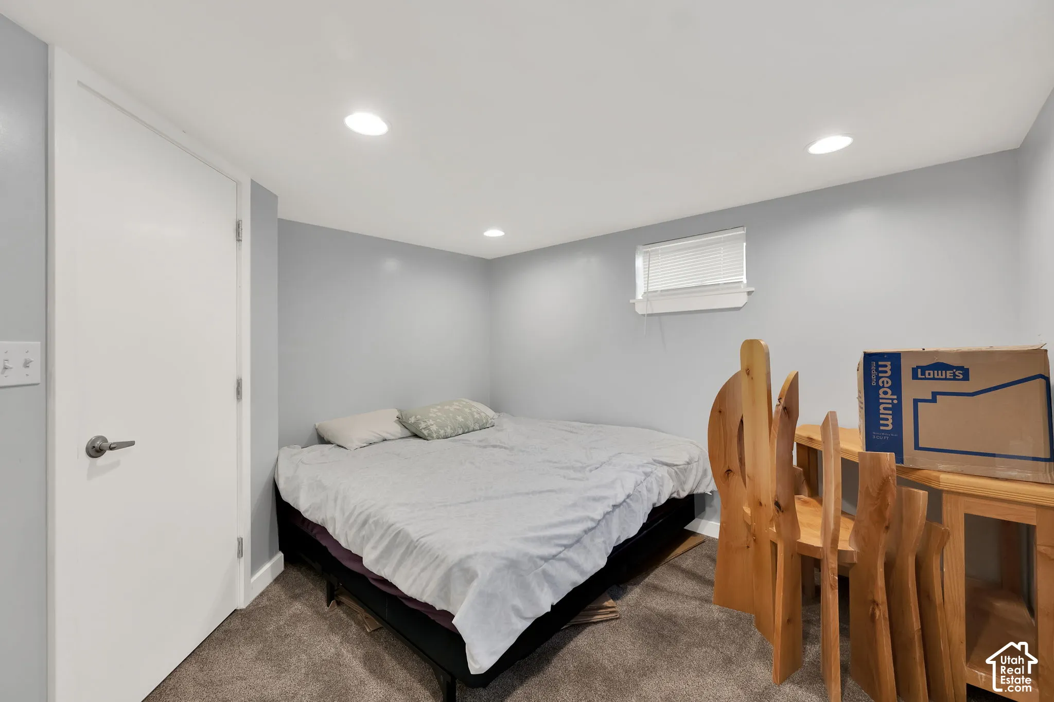 Recessed lighting, light gray wall paint, white trim, and a window with blinds