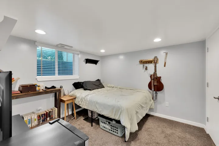 Recessed lighting with light gray walls, white trim, window with blinds, and brown carpet flooring