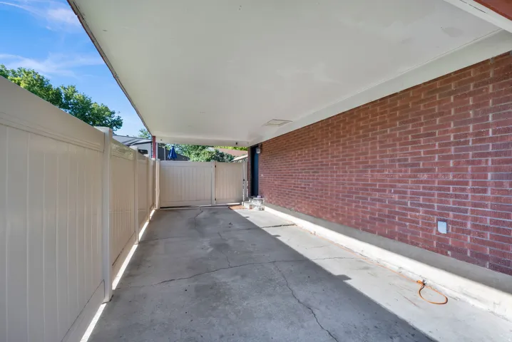 Covered carport with a concrete drive