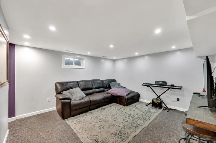 Recessed ceiling lighting, a window opening, and durable carpet flooring