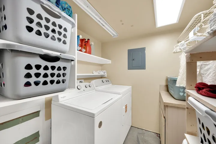 Built-in shelving, overhead fluorescent lighting, and a utility sink with a countertop