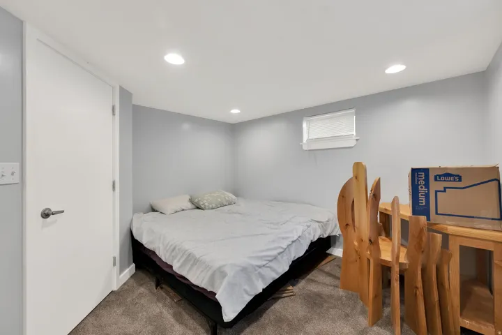 Recessed lighting, light gray wall paint, white trim, and a window with blinds