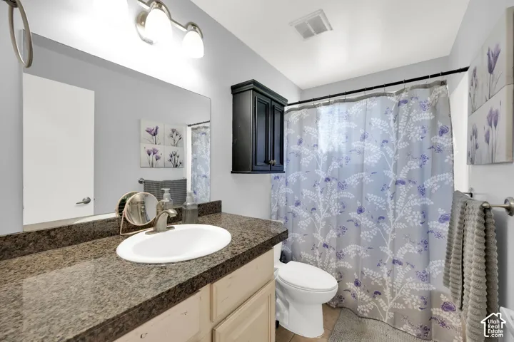 Vanity with integrated sink, expansive mirror, and brushed nickel fixtures