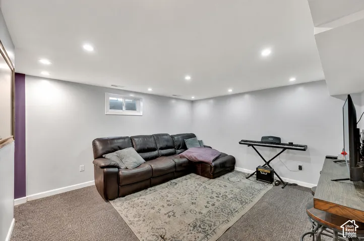 Recessed ceiling lighting, a window opening, and durable carpet flooring