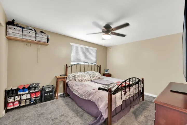 Neutral-toned walls complement the textured carpet flooring