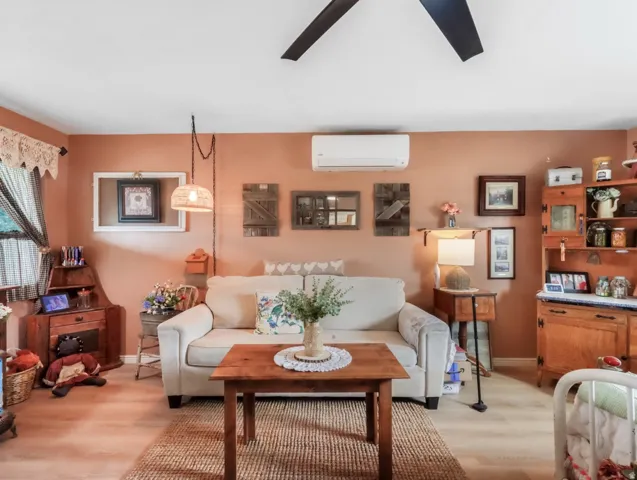 Wood-finish flooring, ceiling fan, and wall-mounted air conditioning unit