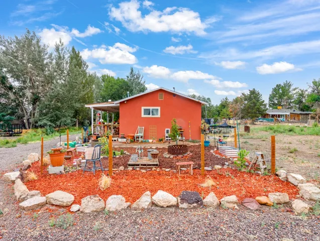 Red exterior with white trim windows and a covered patio