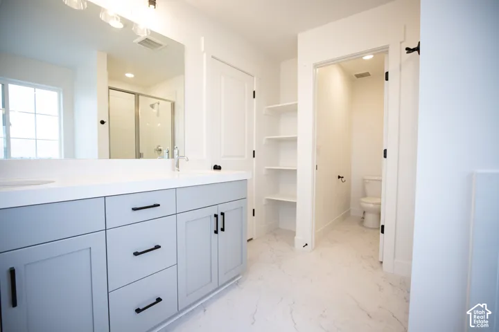 Primary bathroom featuring dual vanity and separate tub and shower