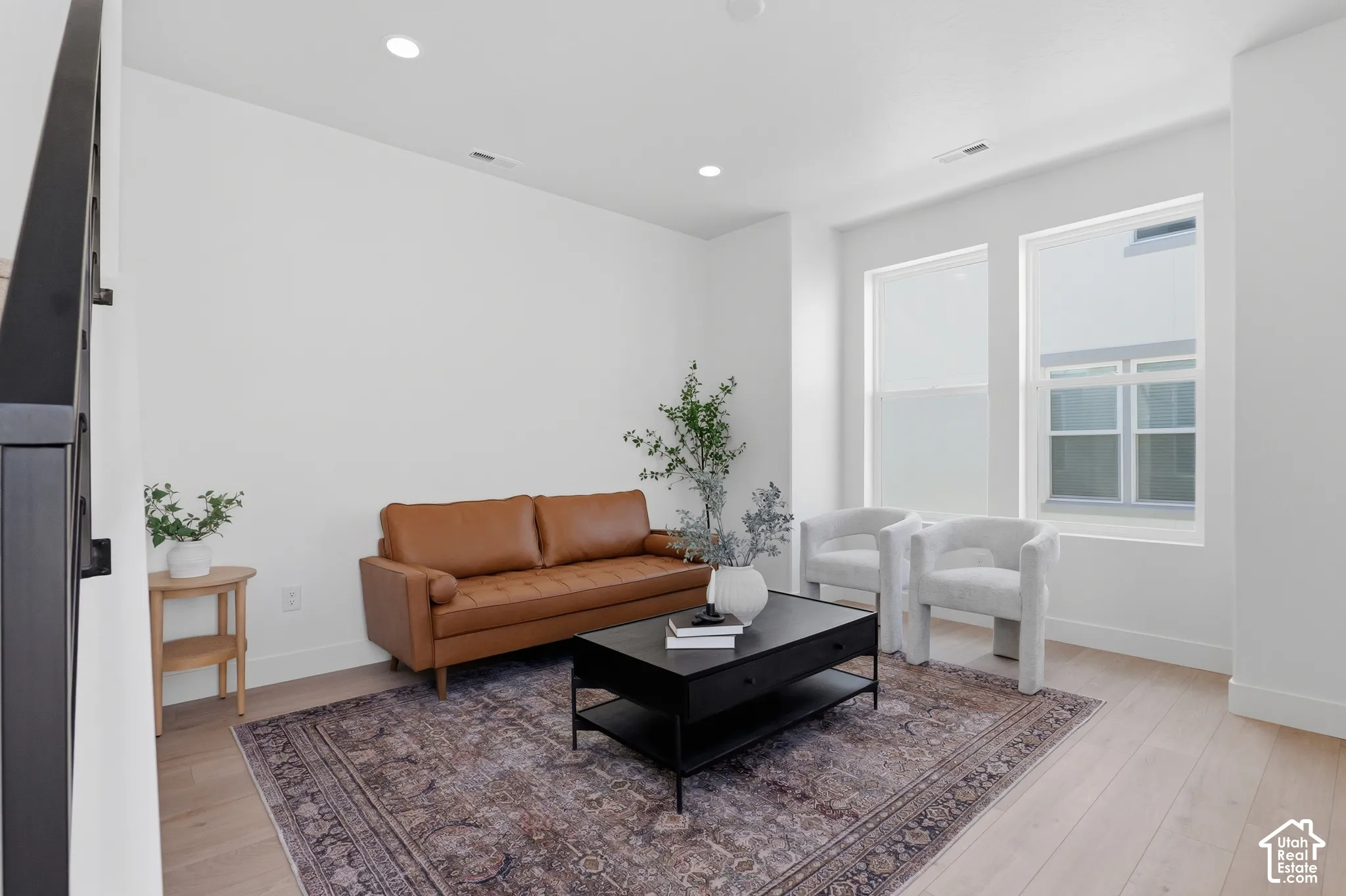 Light wood-finish flooring with white baseboards