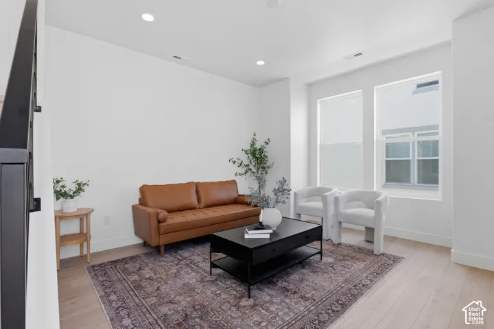 Light wood-finish flooring with white baseboards